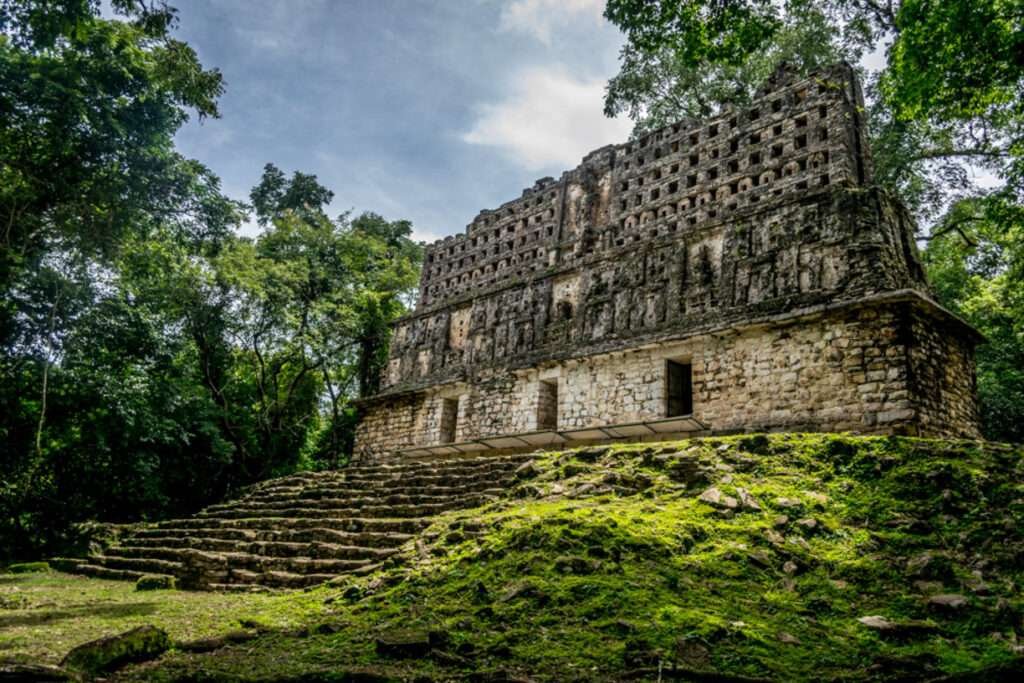 Ein Zeremonialgebäude mit verzierten Fassaden in den Ruinen von Bonampak, eingebettet in den Regenwald